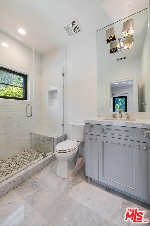 1348 Marinette Road Pacific Palisades, CA 90272 - Photo 40 of 50 a spacious bathroom with a toilet sink and mirror