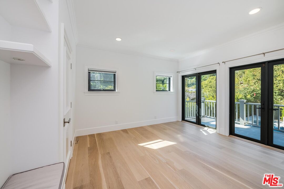 1348 Marinette Road Pacific Palisades, CA 90272 - Photo 45 of 50 a view of an empty room with wooden floor and a window