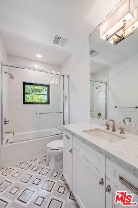 1348 Marinette Road Pacific Palisades, CA 90272 - Photo 47 of 50 a bathroom with a granite countertop toilet sink and mirror