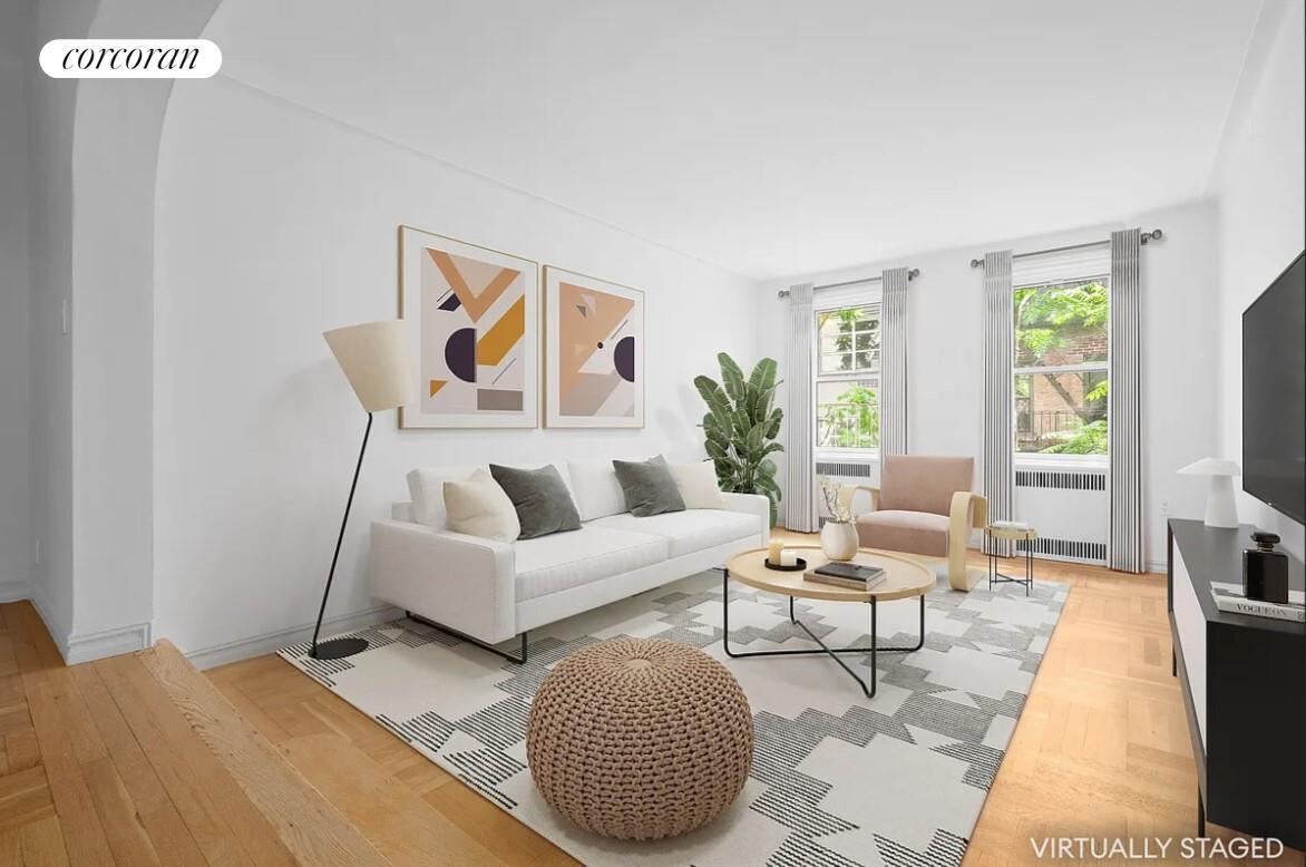 210 West 19th Street, Unit 4J Manhattan, NY 10011 - Photo 3 of 13 a living room with furniture and a flat screen tv