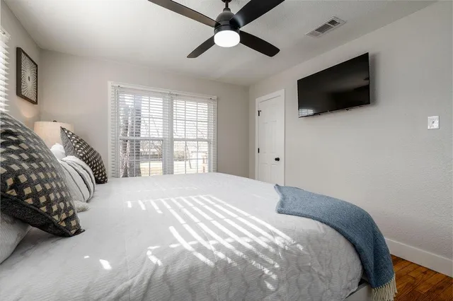 a bedroom with a bed and a flat screen tv