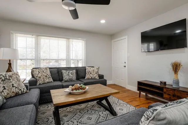 a living room with furniture and a flat screen tv