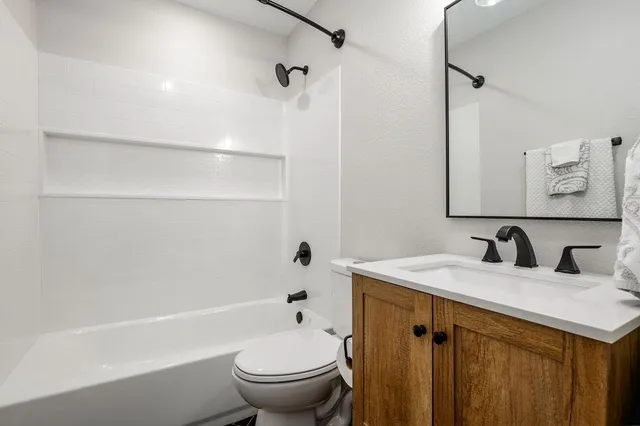 a bathroom with a sink toilet and shower