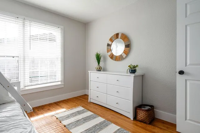 a room with a window and a mirror