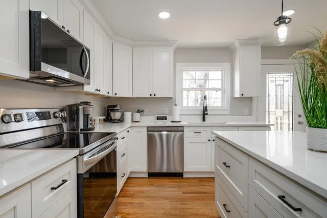 a kitchen with a sink stove and microwave