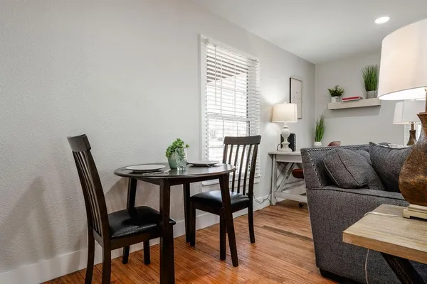 a view of a dining room with furniture and wooden floor