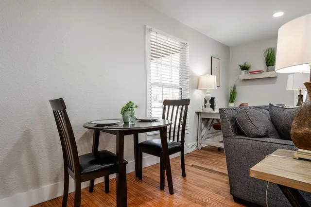 a view of a dining room with furniture and wooden floor