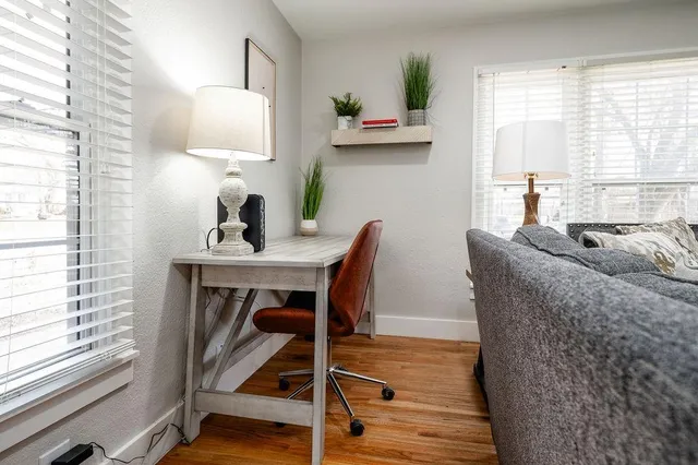a living room with furniture and a wooden floor