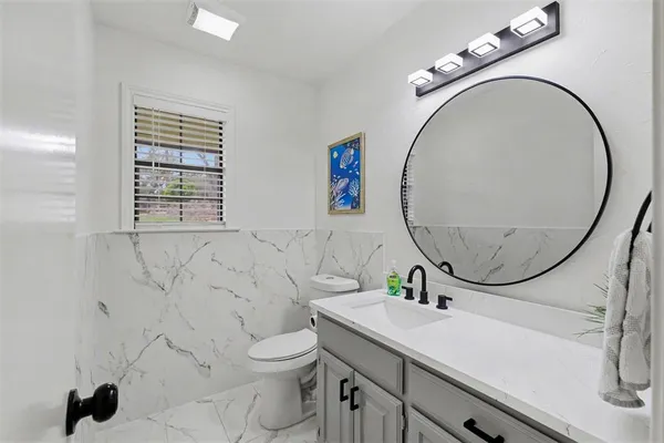 a bathroom with a sink a mirror and a toilet