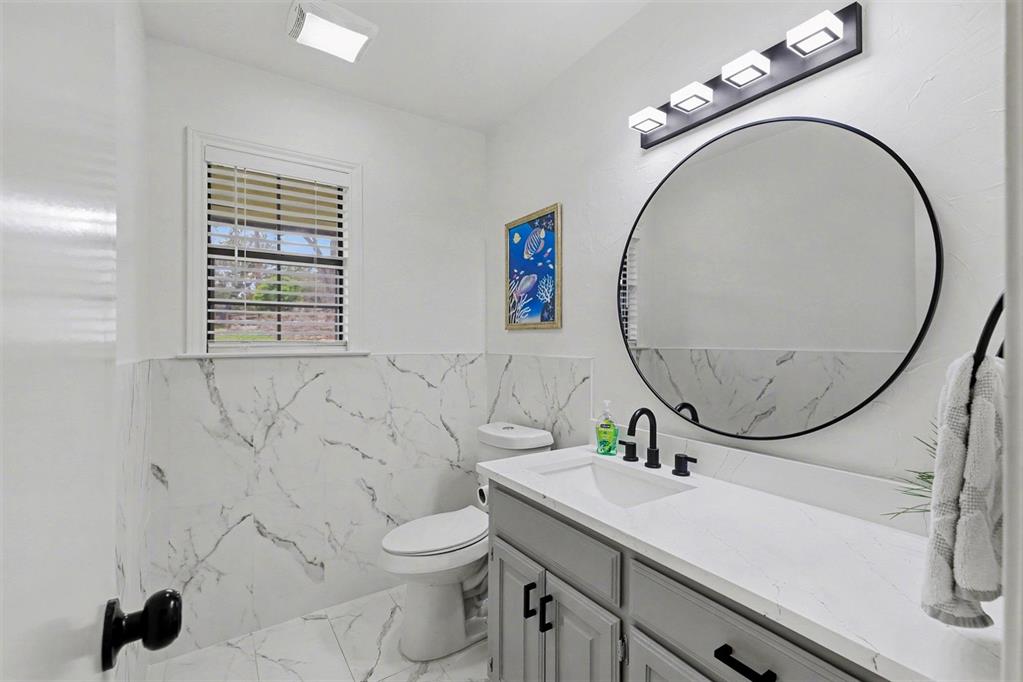 6746 Talbot Parkway Dallas, TX 75232 - Photo 18 of 34 a bathroom with a sink a mirror and a toilet