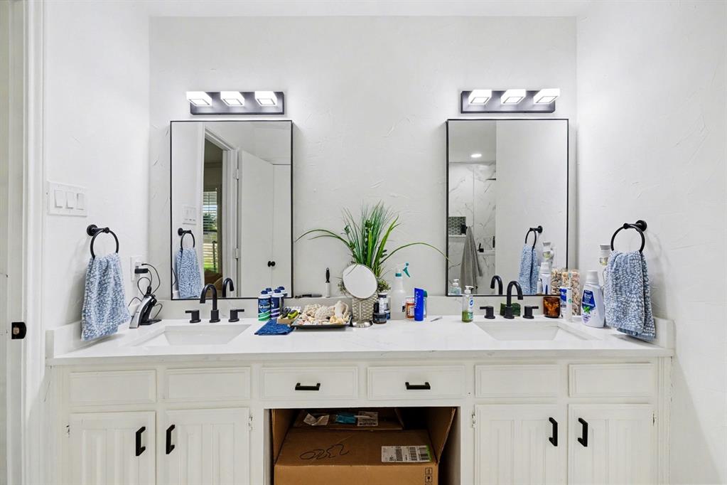 6746 Talbot Parkway Dallas, TX 75232 - Photo 22 of 34 a bathroom with double vanity sink and a mirror