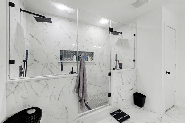 a bathroom with a granite countertop sink a toilet and shower