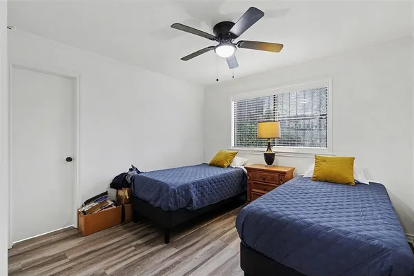 a bedroom with two beds and a chandelier