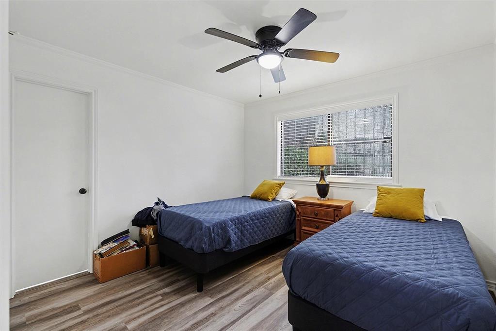 6746 Talbot Parkway Dallas, TX 75232 - Photo 27 of 34 a bedroom with two beds and a chandelier