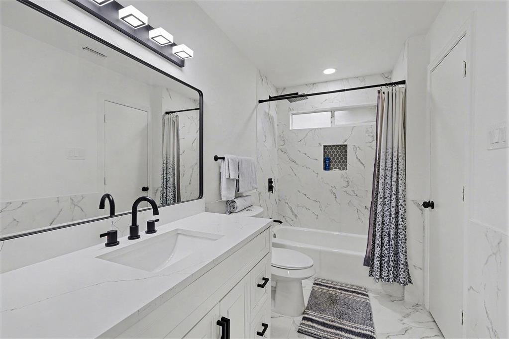 6746 Talbot Parkway Dallas, TX 75232 - Photo 28 of 34 a bathroom with a sink a toilet and shower