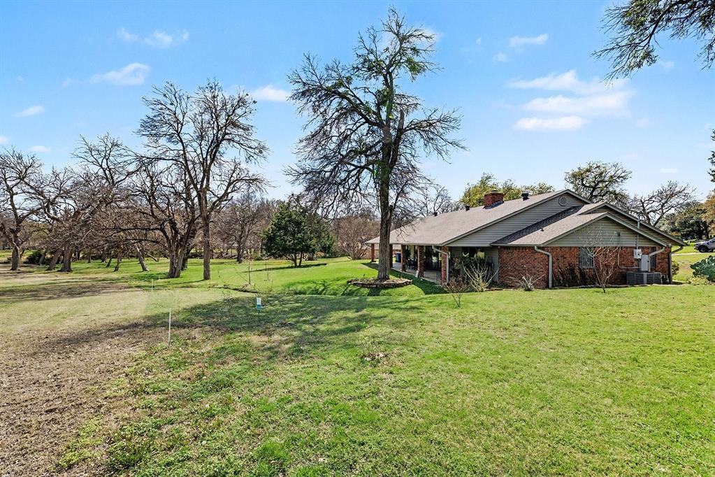 6746 Talbot Parkway Dallas, TX 75232 - Photo 31 of 34 a view of a house with a big yard and large trees