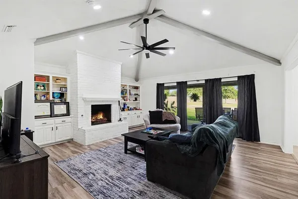 a living room with furniture fireplace and flat screen tv