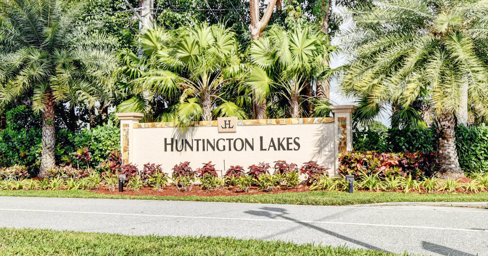 7076 Huntington Lane, Unit 507 Delray Beach, FL 33446 - Photo 1 of 48 a sign on the side of a building