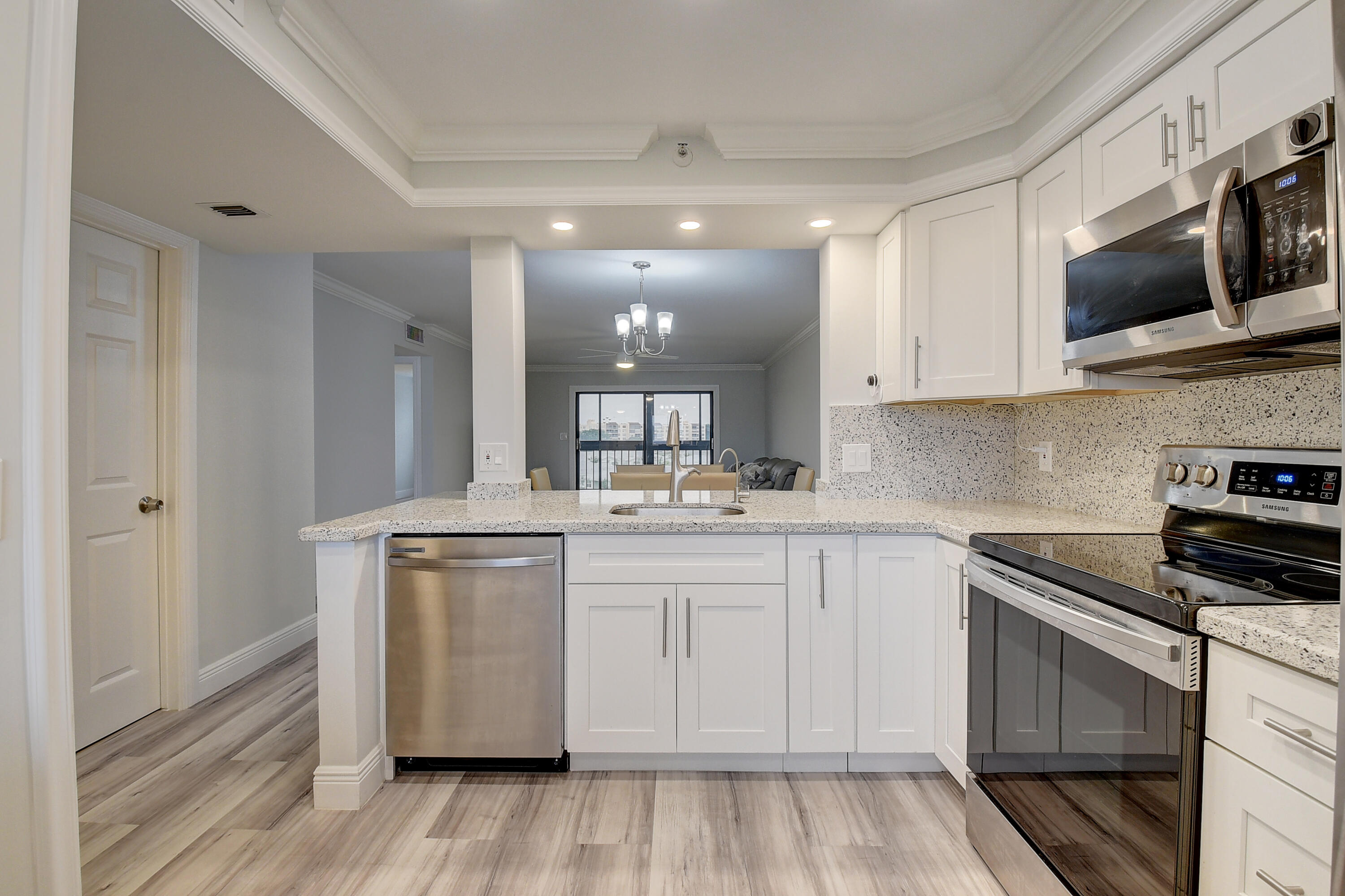 7076 Huntington Lane, Unit 507 Delray Beach, FL 33446 - Photo 14 of 48 a kitchen with stainless steel appliances granite countertop a stove and a sink