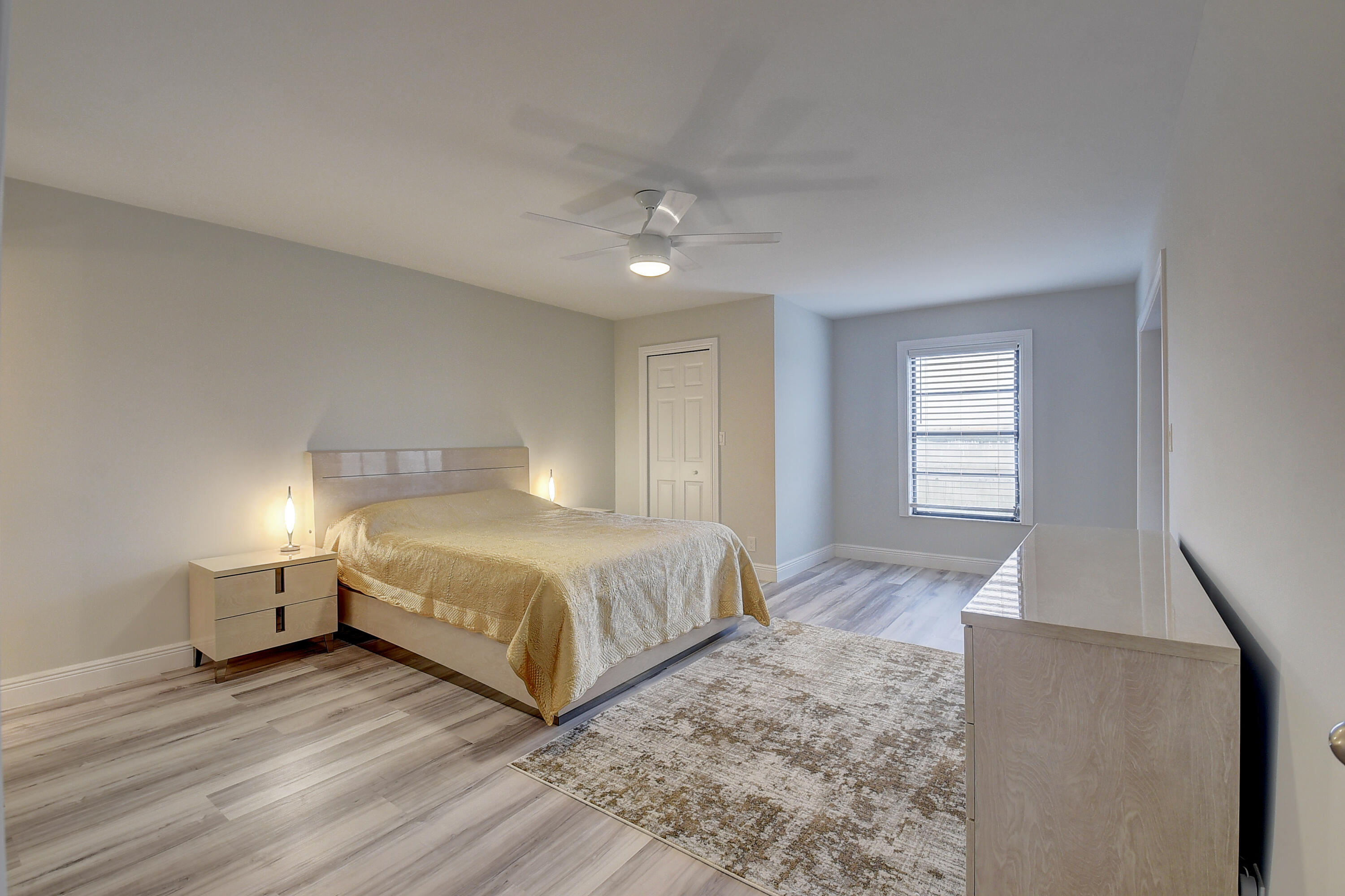 7076 Huntington Lane, Unit 507 Delray Beach, FL 33446 - Photo 16 of 48 a spacious bedroom with a bed and window