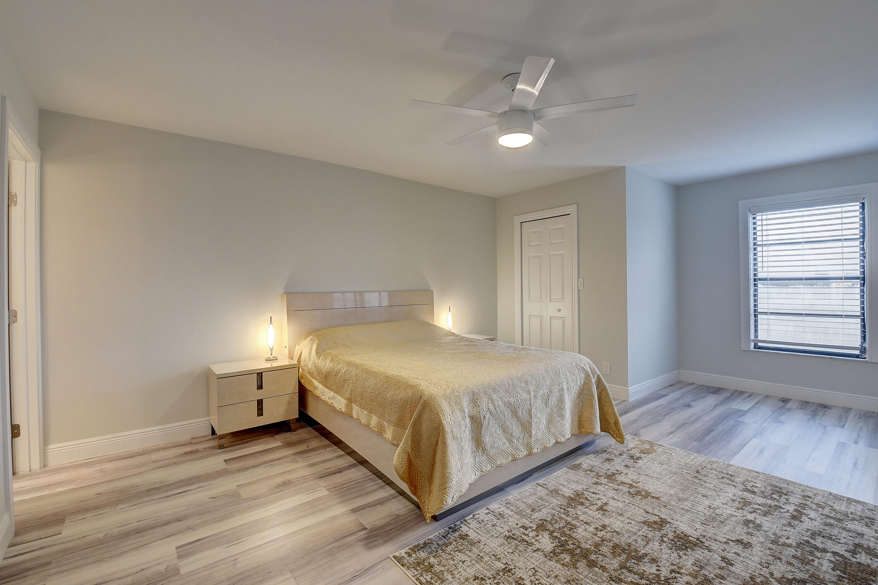 7076 Huntington Lane, Unit 507 Delray Beach, FL 33446 - Photo 17 of 48 a bedroom with a bed and wooden floor