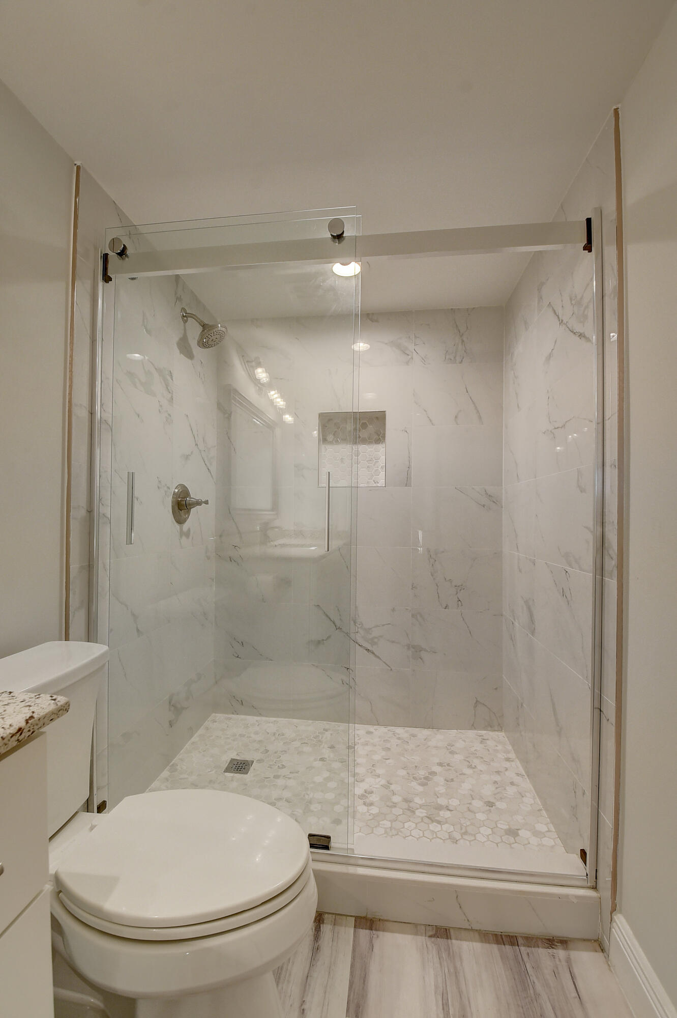 7076 Huntington Lane, Unit 507 Delray Beach, FL 33446 - Photo 20 of 48 a bathroom with a shower a toilet and a sink