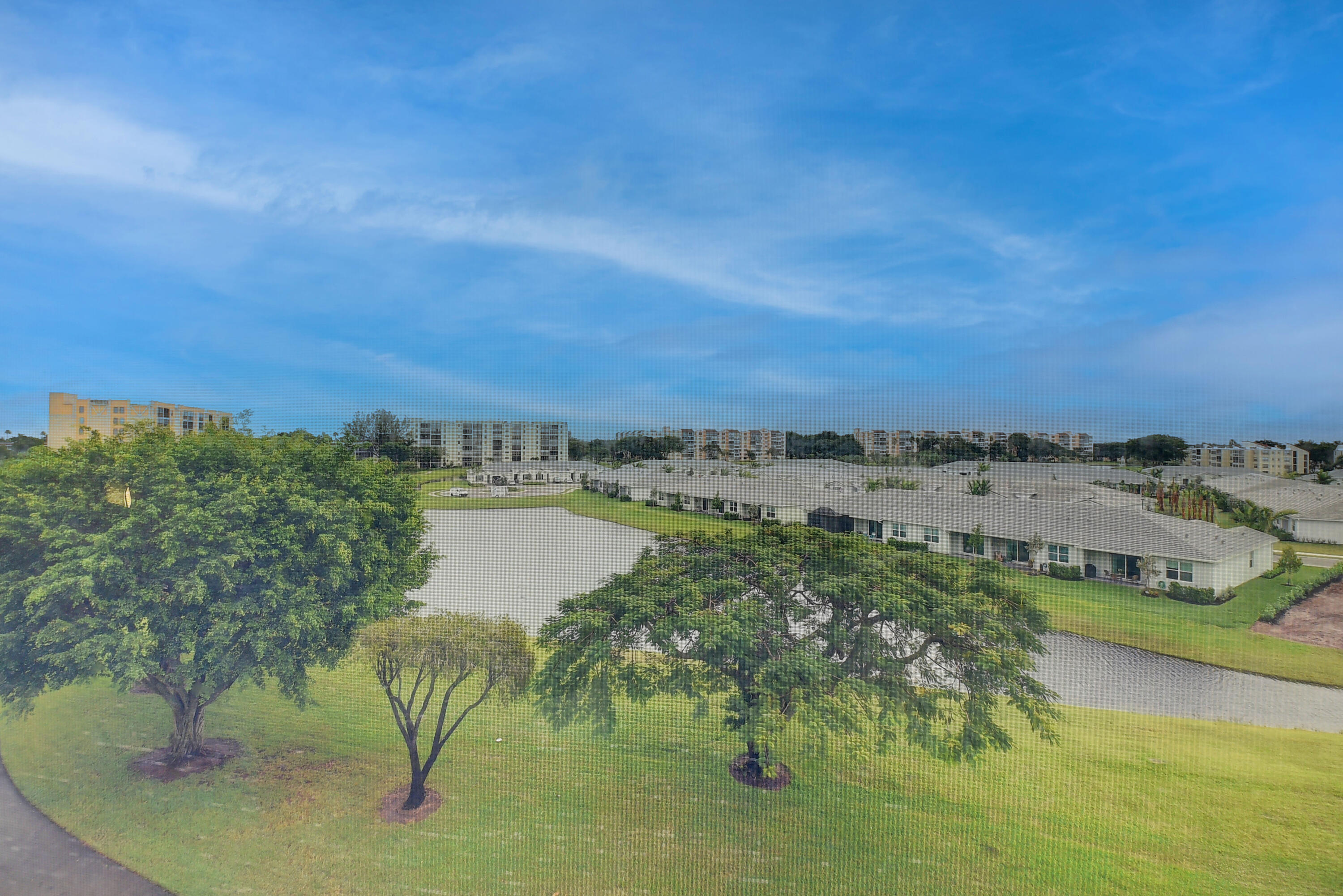 7076 Huntington Lane, Unit 507 Delray Beach, FL 33446 - Photo 27 of 48 a view of a lake with a yard