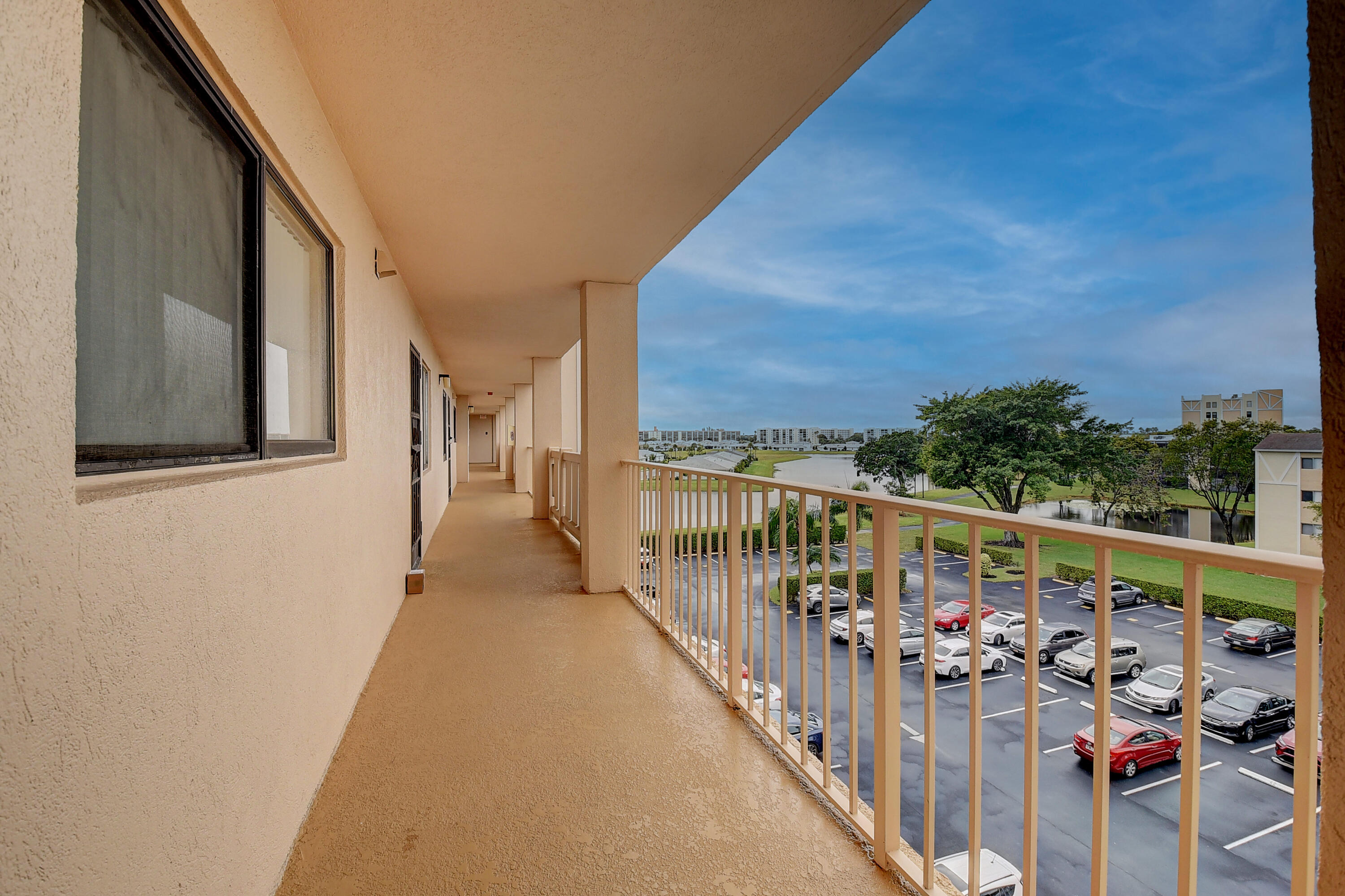 7076 Huntington Lane, Unit 507 Delray Beach, FL 33446 - Photo 3 of 48 a view of a balcony with couches and wooden floor