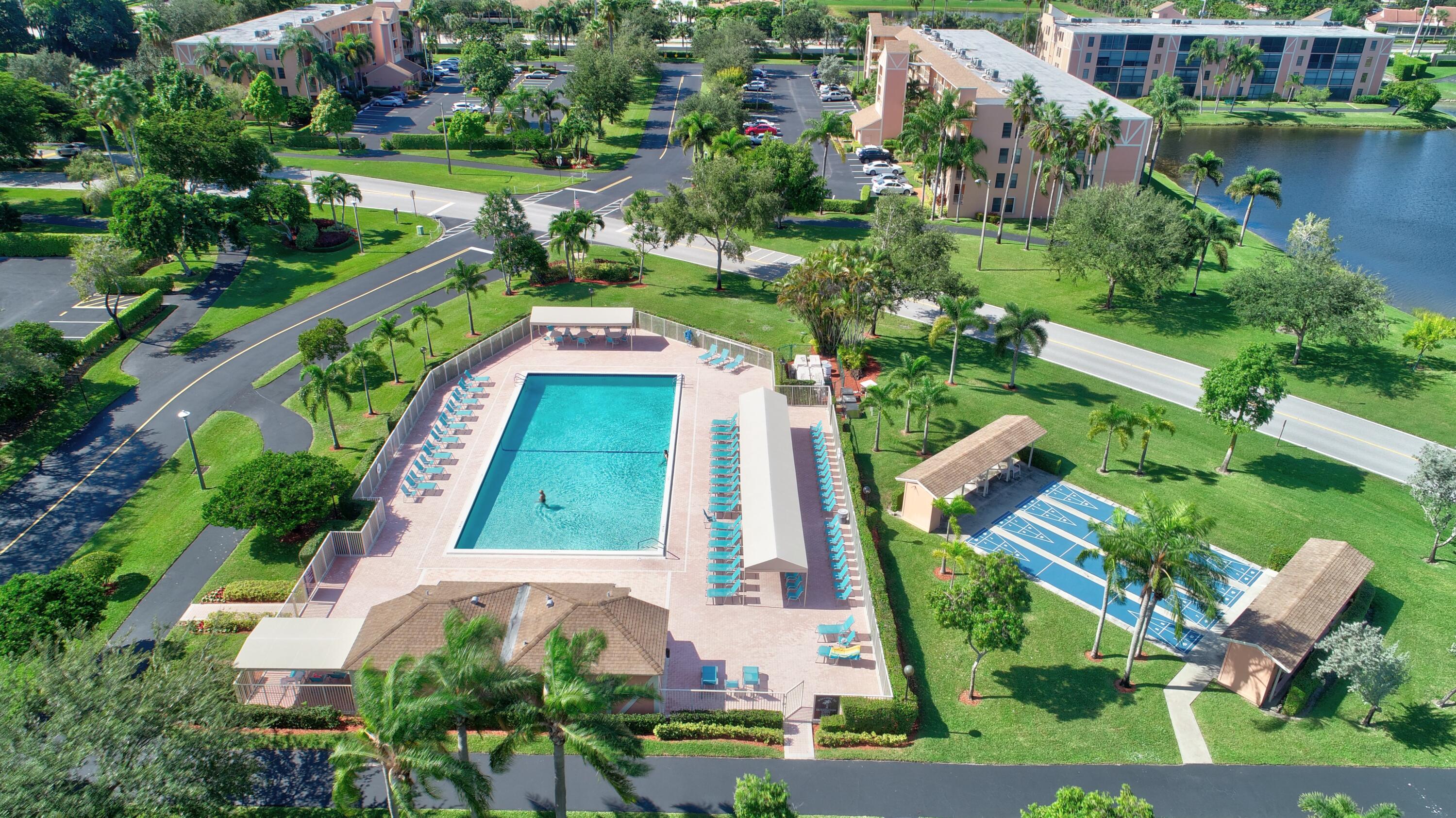 7076 Huntington Lane, Unit 507 Delray Beach, FL 33446 - Photo 44 of 48 an aerial view of a house with outdoor space pool patio and lake view