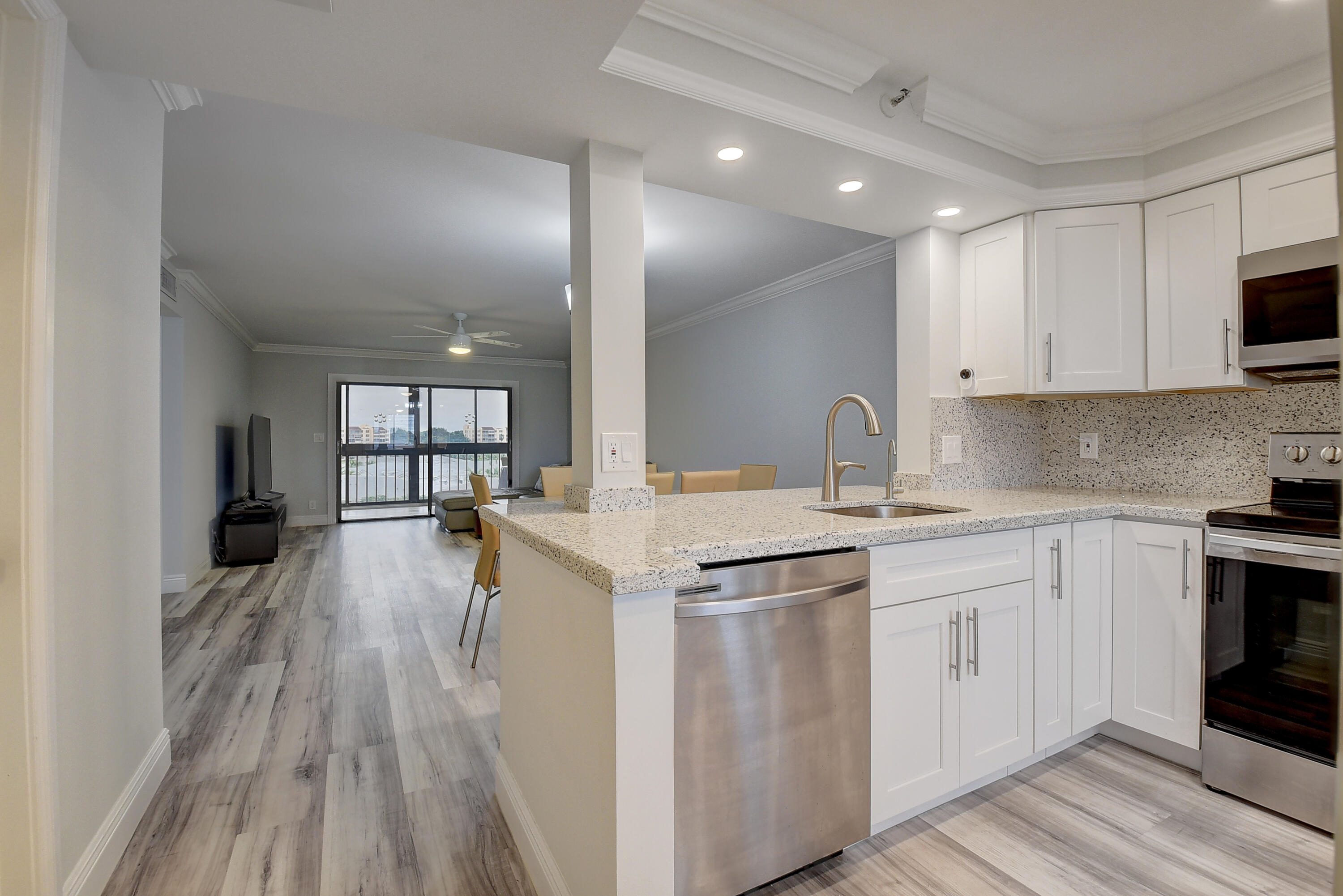 7076 Huntington Lane, Unit 507 Delray Beach, FL 33446 - Photo 6 of 48 a kitchen with a sink stove and cabinets