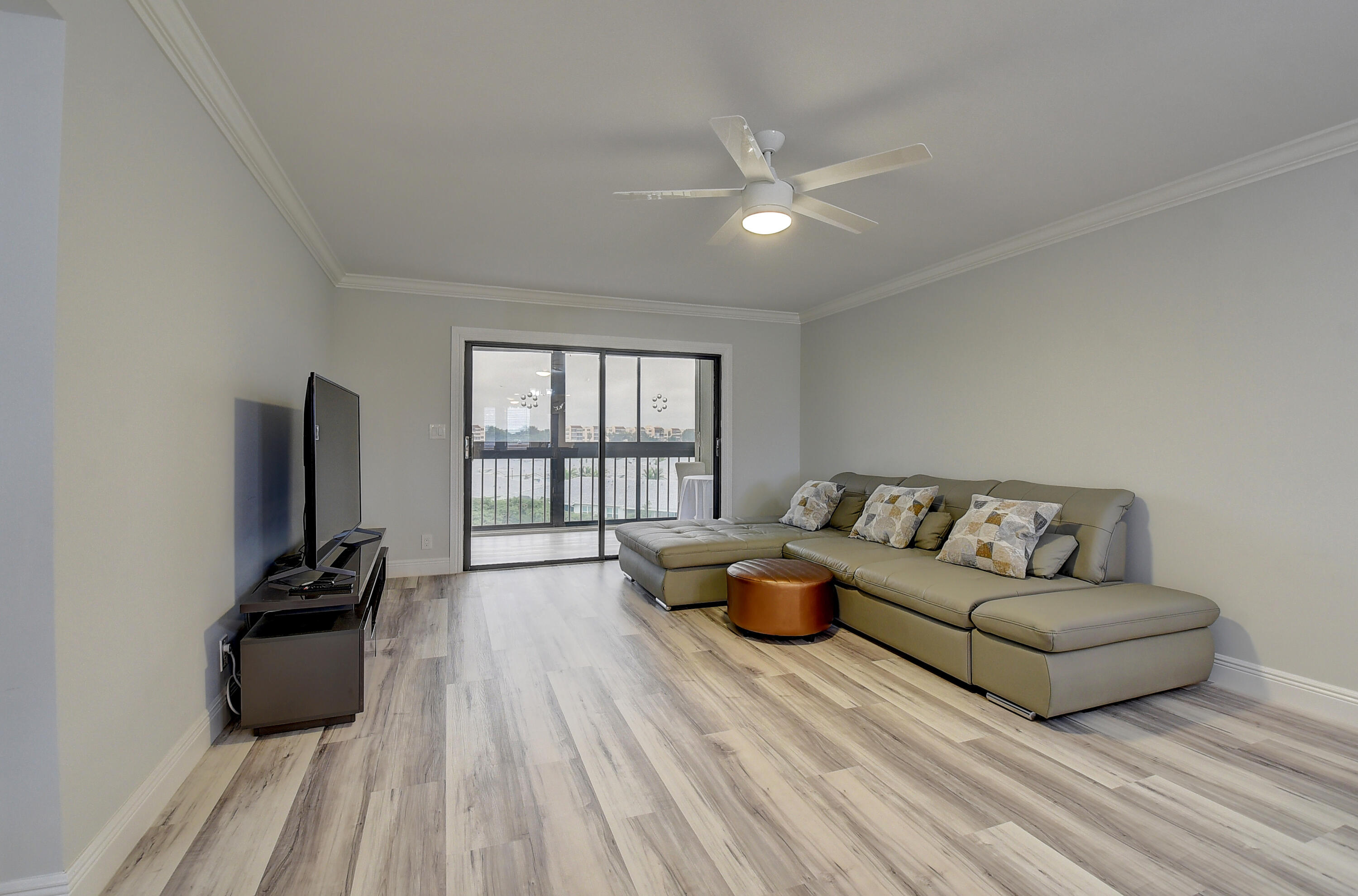 7076 Huntington Lane, Unit 507 Delray Beach, FL 33446 - Photo 8 of 48 a living room with furniture and a flat screen tv