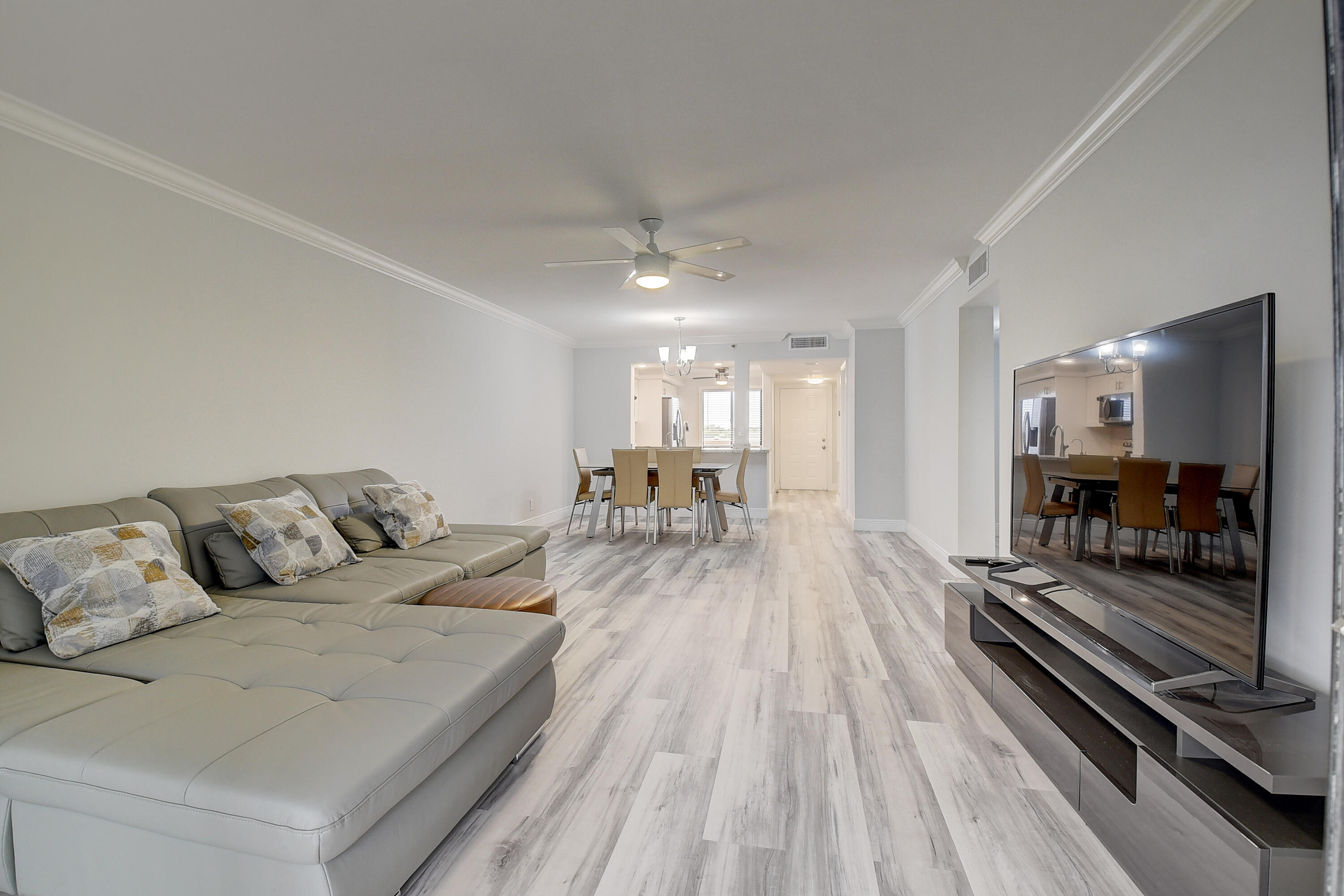 7076 Huntington Lane, Unit 507 Delray Beach, FL 33446 - Photo 10 of 48 a living room with furniture and a wooden floor