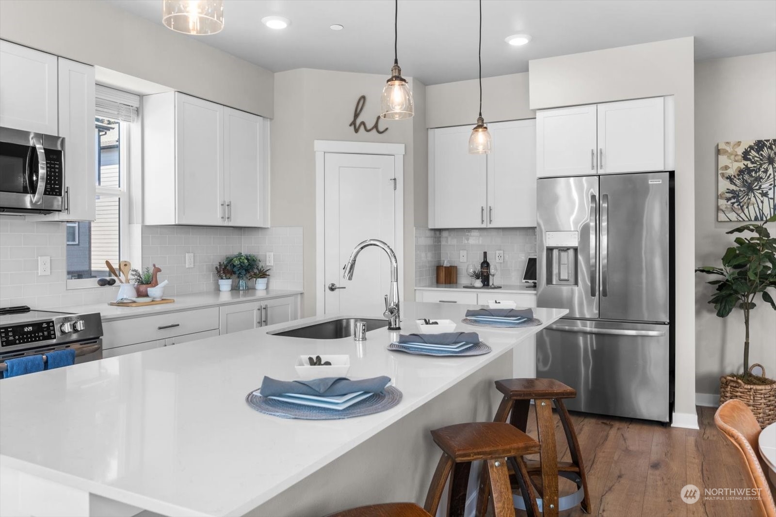 22929 80th Place West, Unit C Edmonds, WA 98026 - Photo 11 of 36 a kitchen with stainless steel appliances granite countertop a refrigerator a sink dishwasher a stove and white cabinets with wooden floor