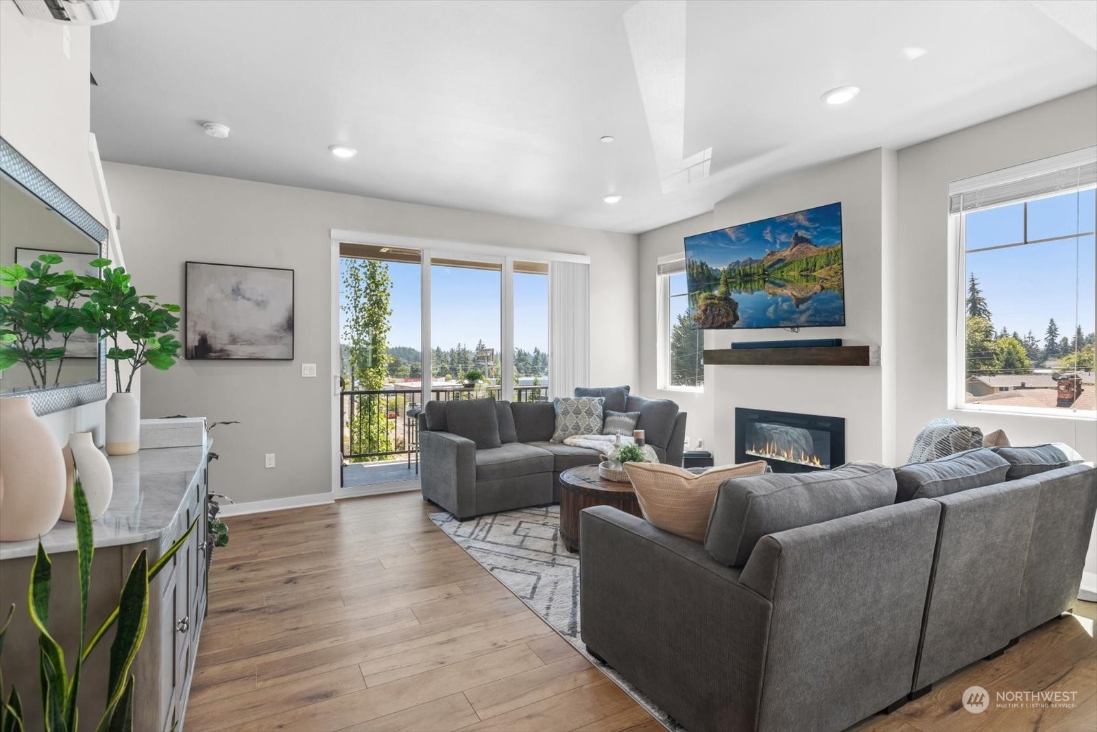 22929 80th Place West, Unit C Edmonds, WA 98026 - Photo 12 of 36 a living room with furniture a fireplace and a potted plant