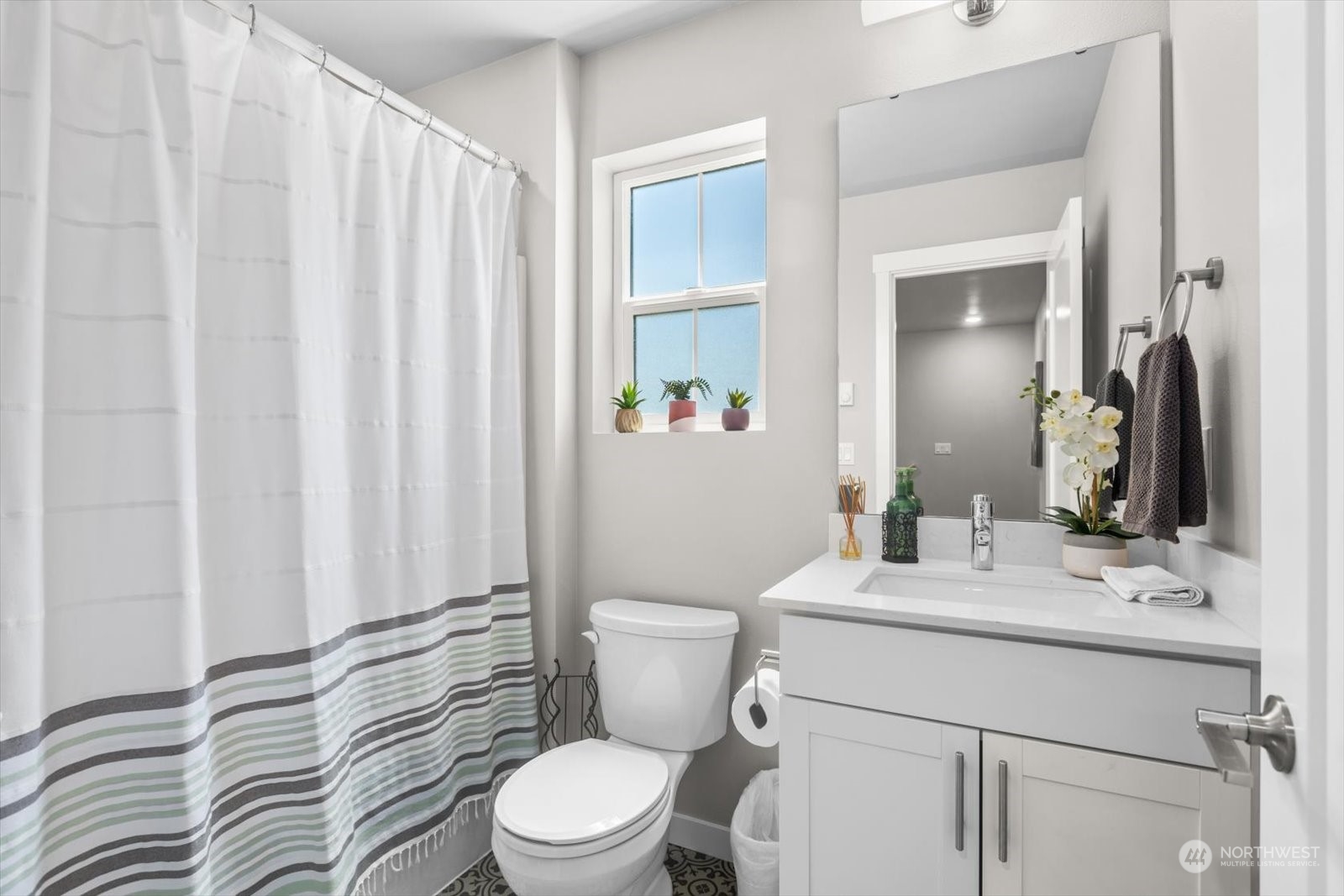 22929 80th Place West, Unit C Edmonds, WA 98026 - Photo 23 of 36 a bathroom with a sink a toilet and shower curtain