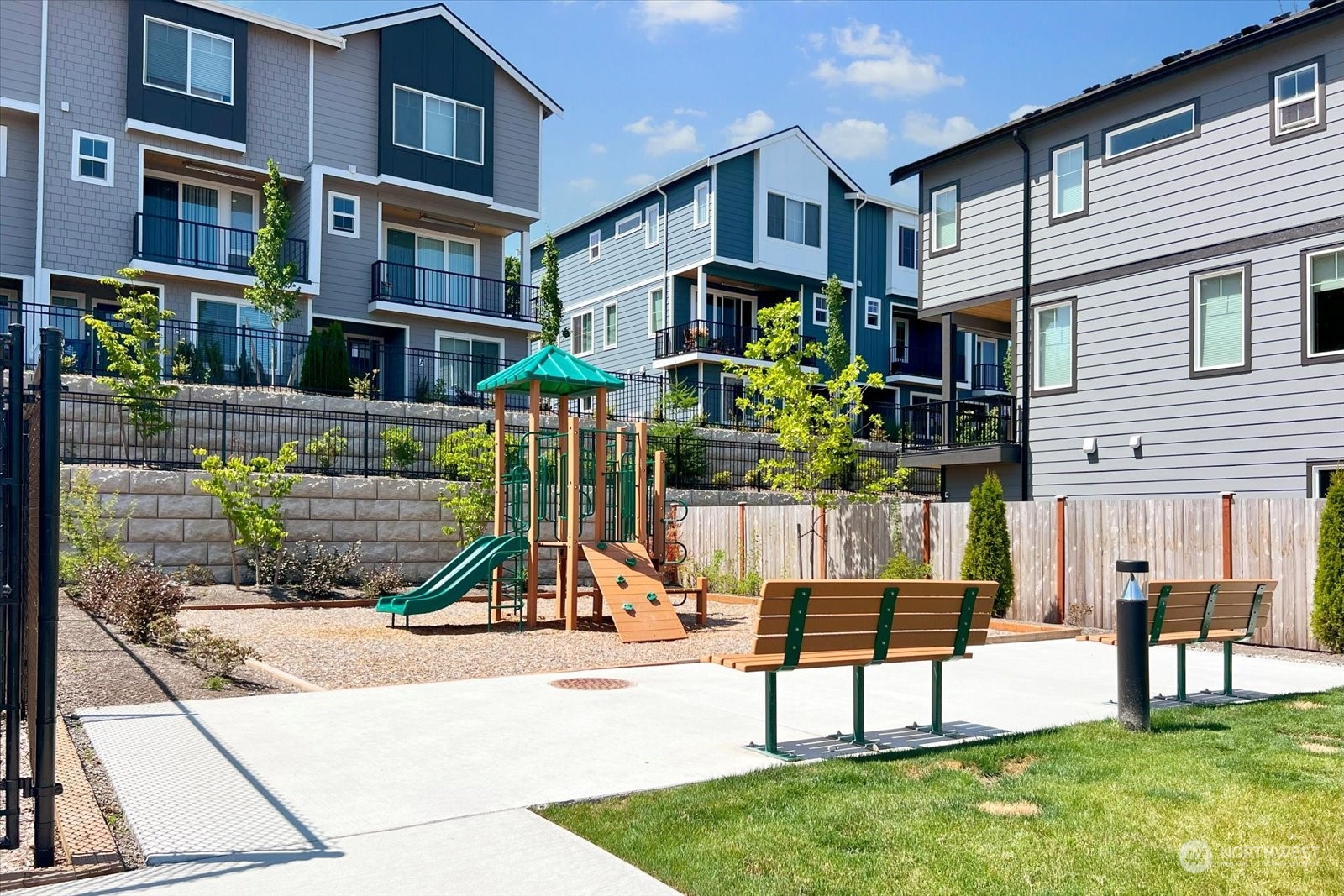 22929 80th Place West, Unit C Edmonds, WA 98026 - Photo 31 of 36 a view of a brick house with a yard potted plants and a bench
