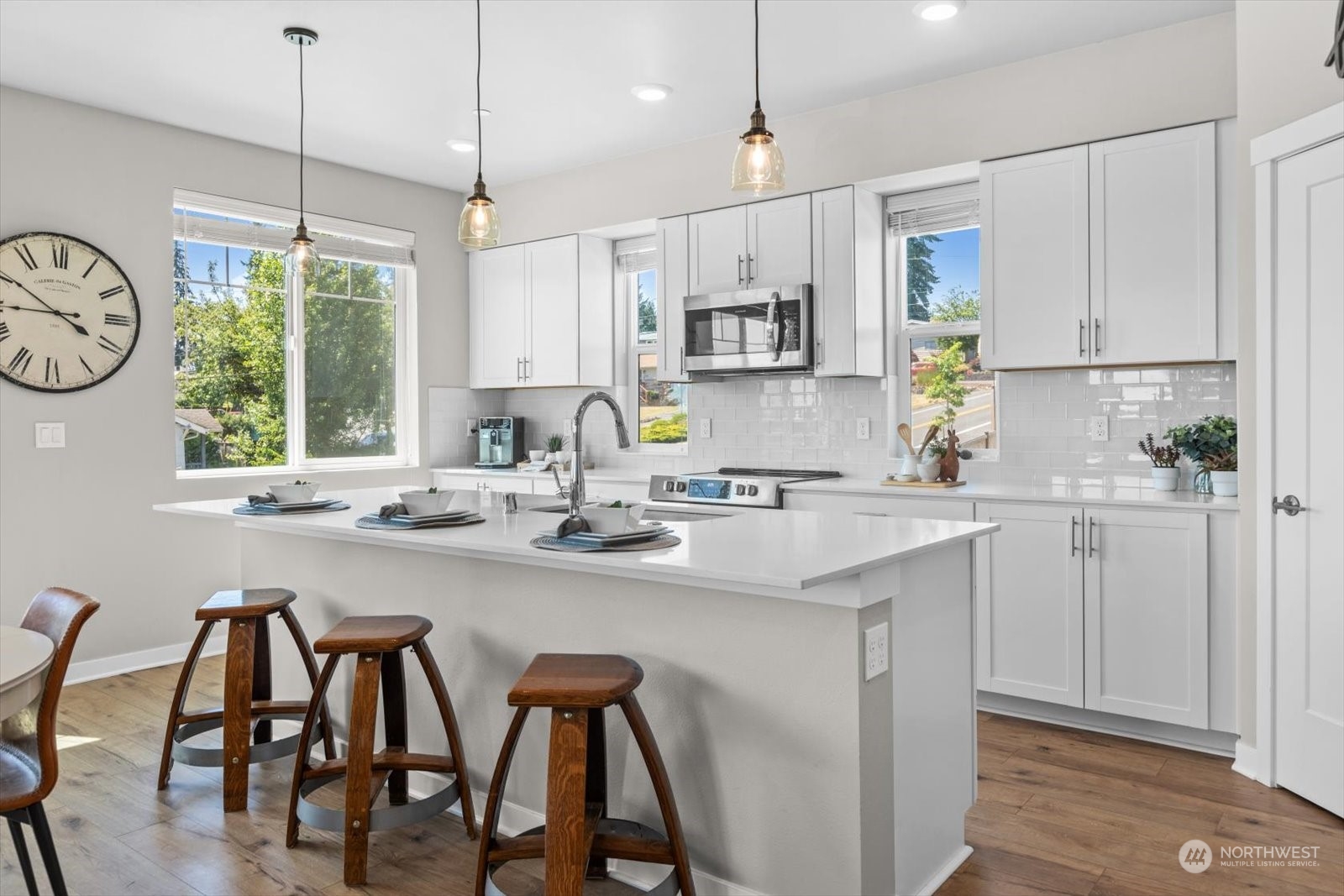 22929 80th Place West, Unit C Edmonds, WA 98026 - Photo 7 of 36 a kitchen with kitchen island a dining table and a sink