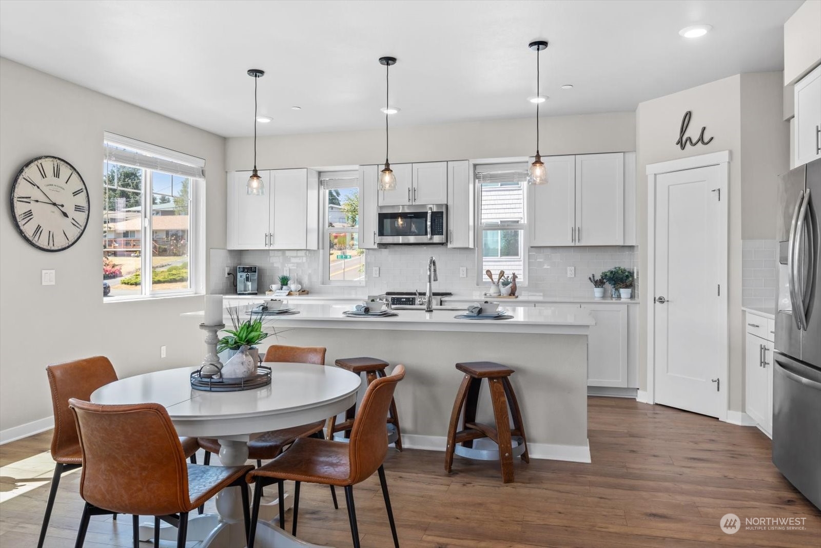22929 80th Place West, Unit C Edmonds, WA 98026 - Photo 8 of 36 a kitchen with stainless steel appliances granite countertop a kitchen island a stove a table and chairs