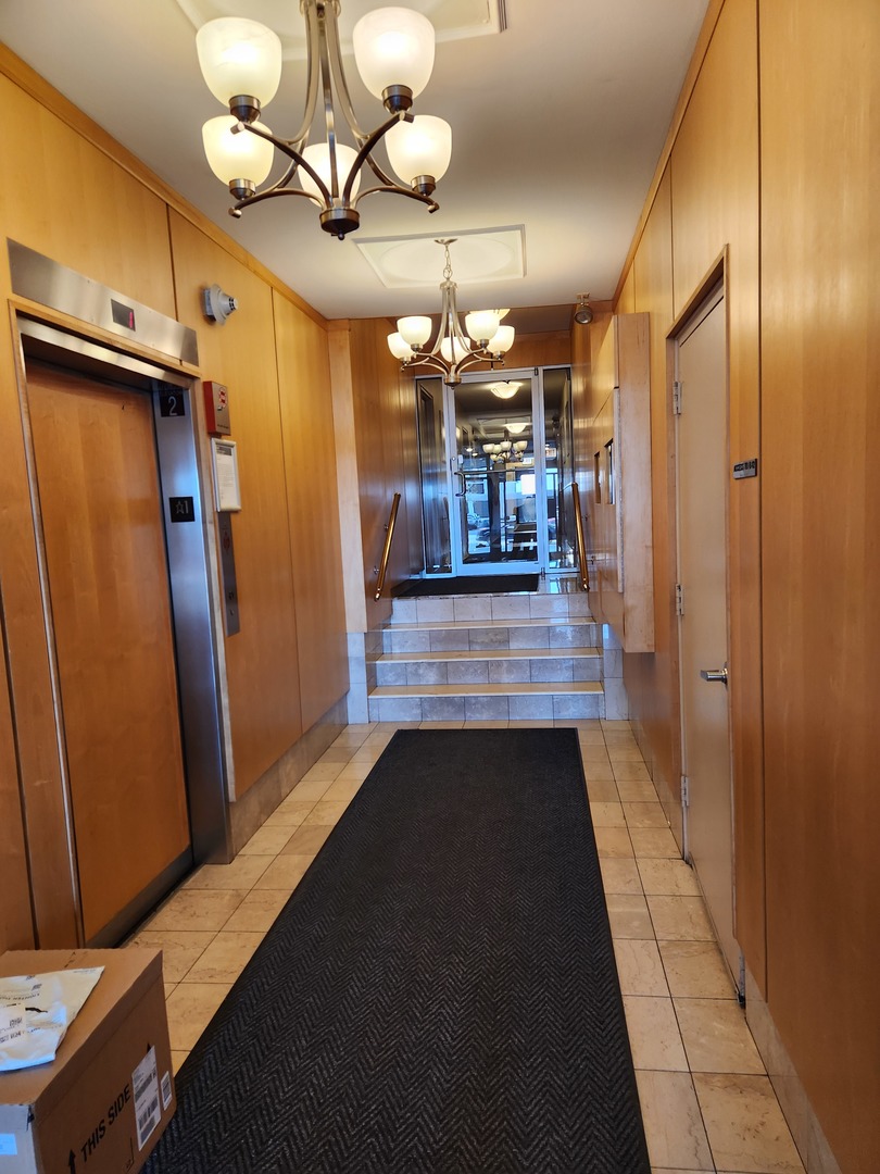6118 North Sheridan Road, Unit 1206 Chicago, IL 60660 - Photo 9 of 9 a view of a hallway with wooden floor