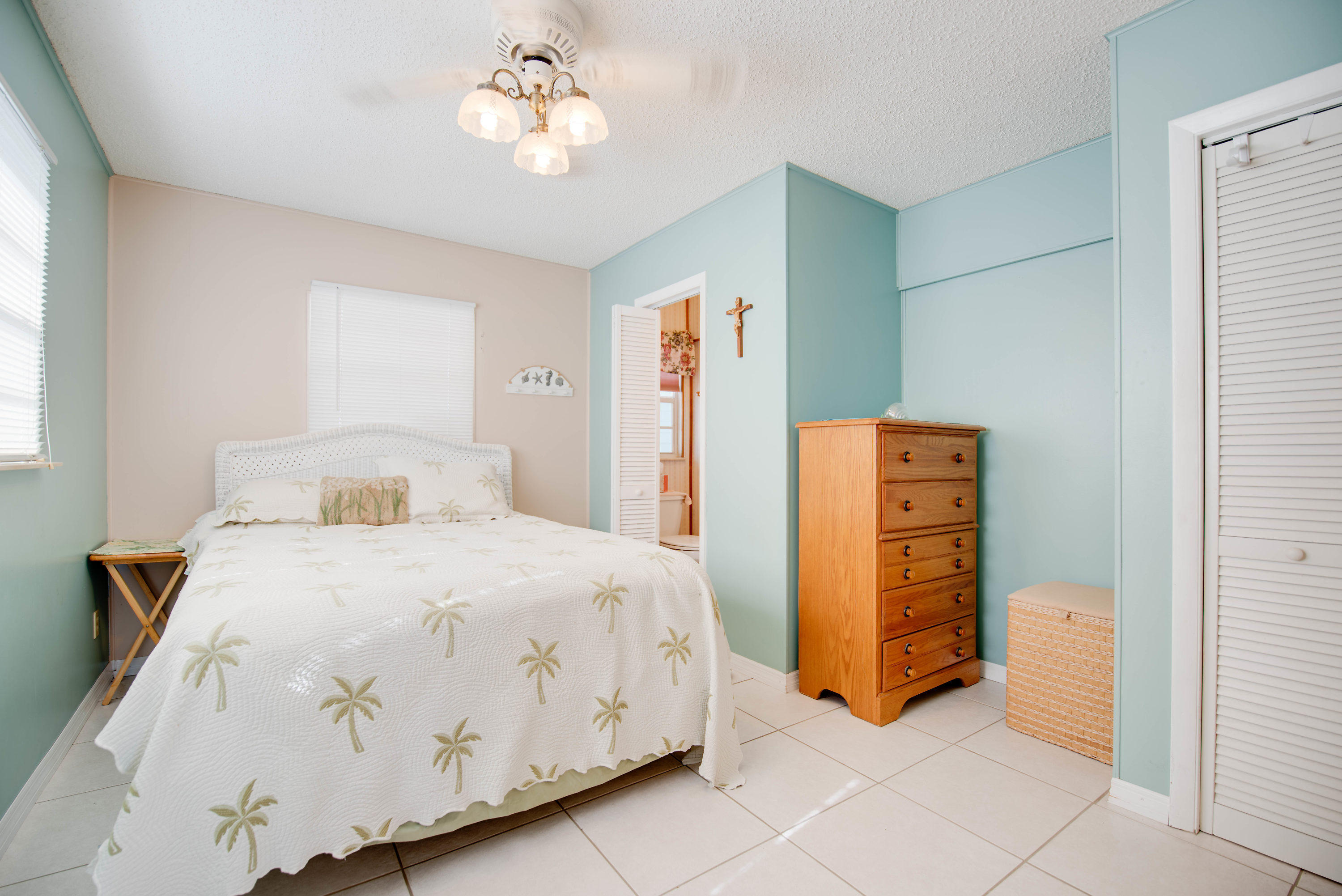 55 Boca Chica Road, Unit 430 Key West, FL 33040 - Photo 13 of 34 a bedroom with a bed and a chandelier
