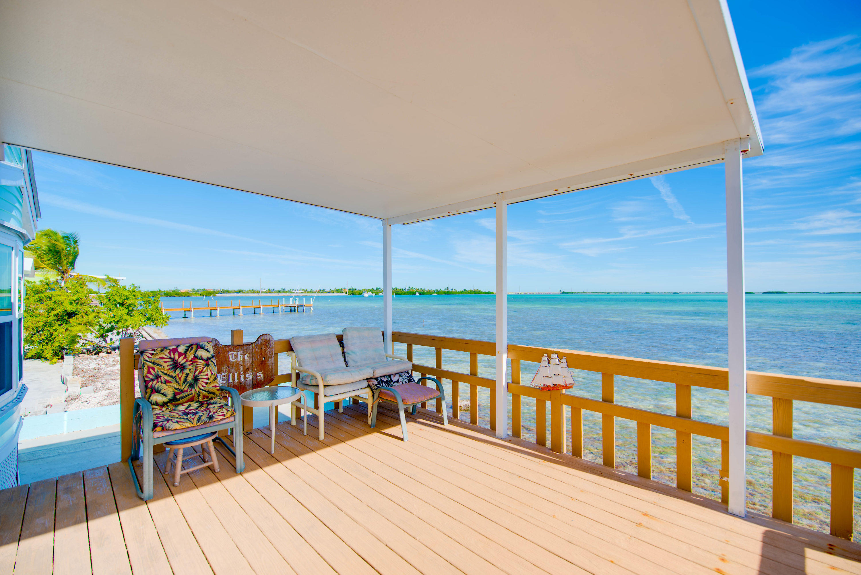 55 Boca Chica Road, Unit 430 Key West, FL 33040 - Photo 30 of 34 a view of a balcony with chairs and wooden floor