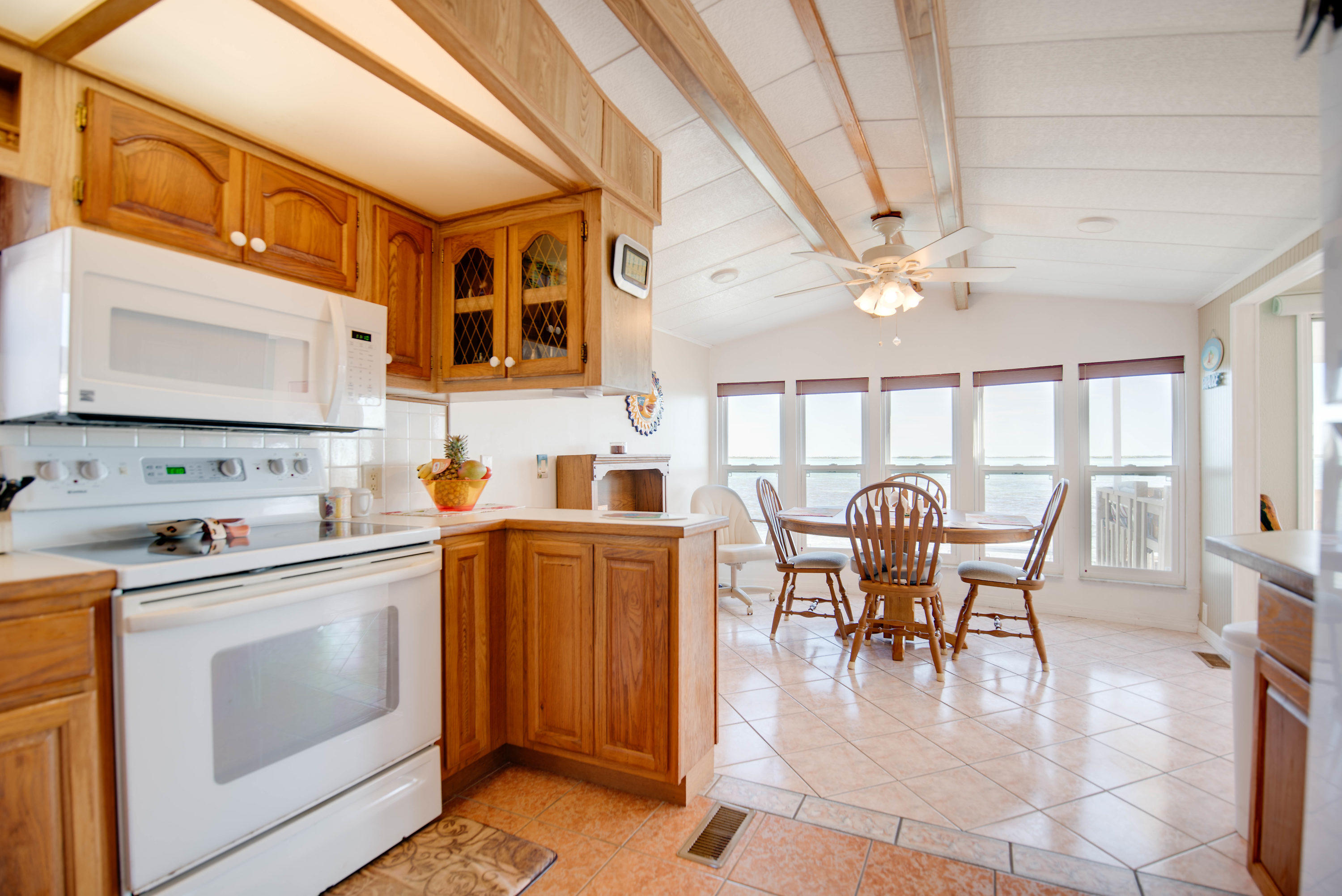 55 Boca Chica Road, Unit 430 Key West, FL 33040 - Photo 8 of 34 a dining hall with stainless steel appliances granite countertop a stove a sink a dining table and chairs with wooden floor