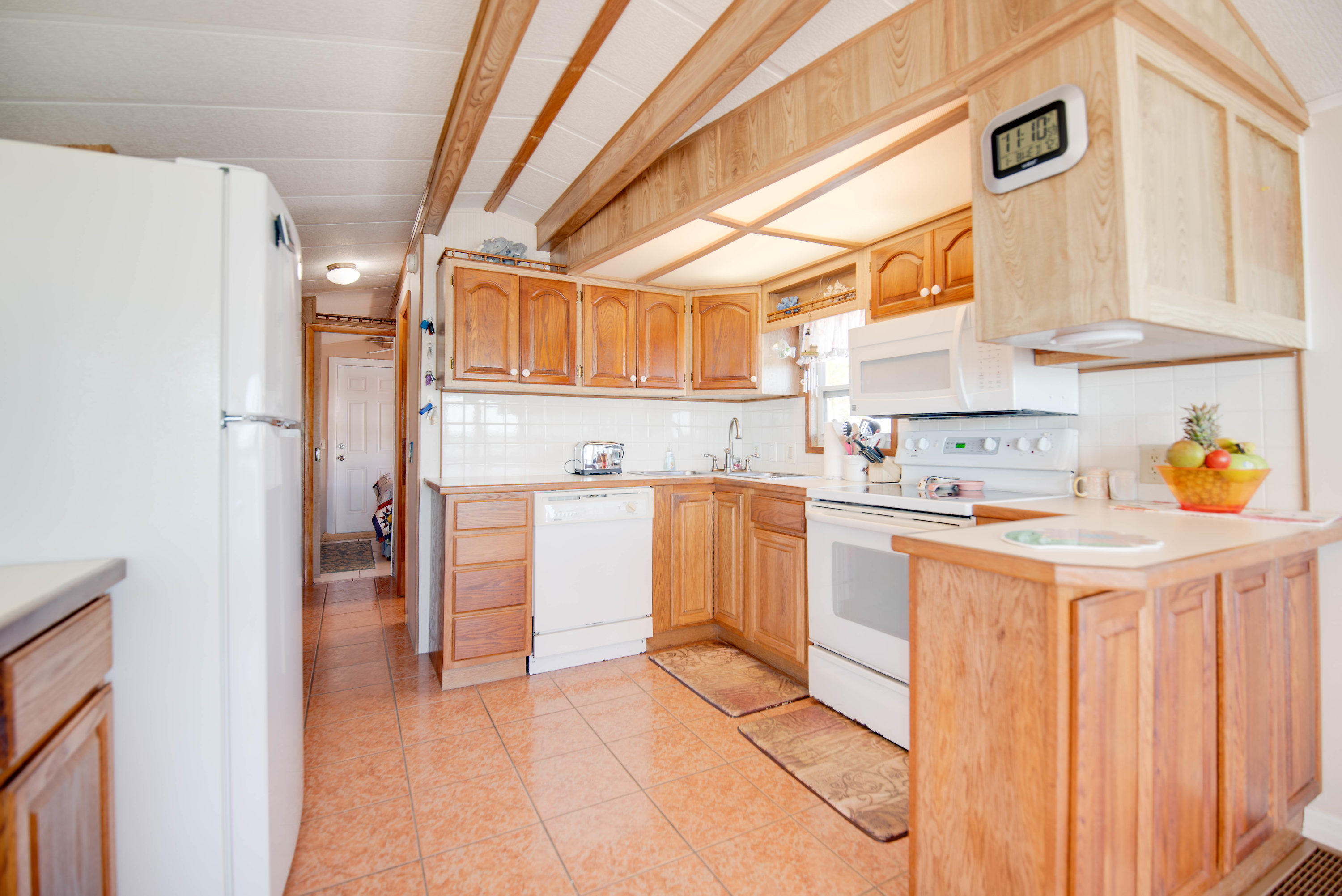 55 Boca Chica Road, Unit 430 Key West, FL 33040 - Photo 10 of 34 a kitchen with a refrigerator and white cabinets