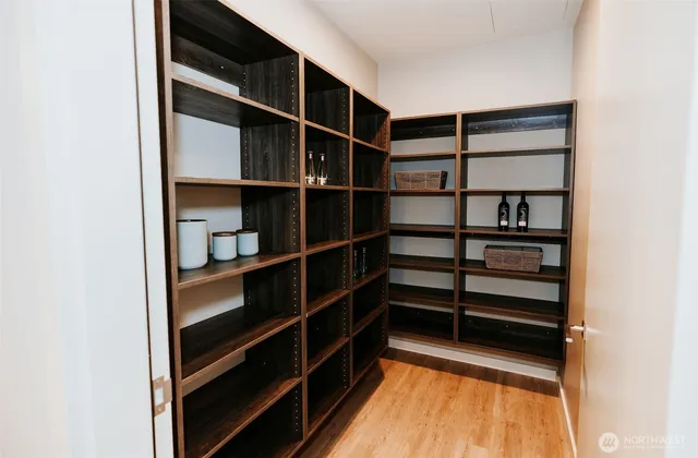 a view of walk in closet with empty racks