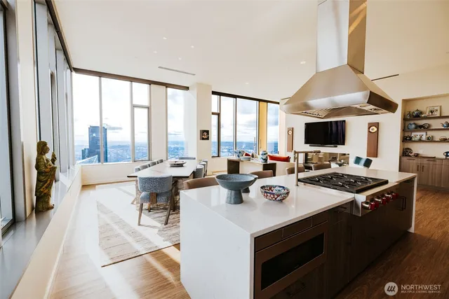 a view of open kitchen with dining table and chairs