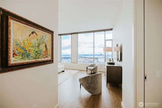 a living room with furniture large window and outer view