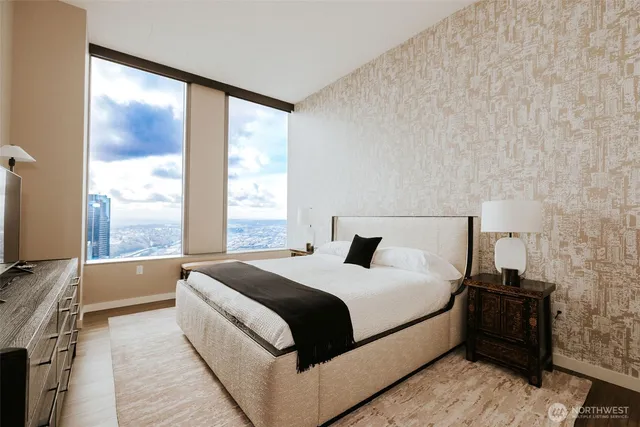 a bedroom with a bed and a large window