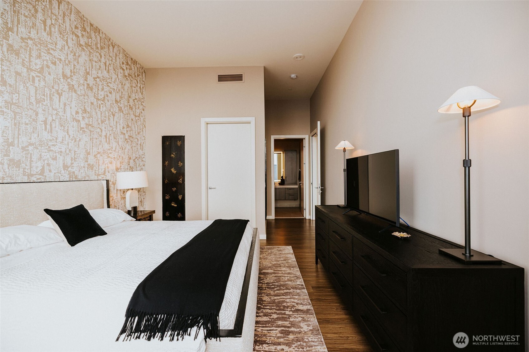 1340 4th Avenue, Unit 5803 Seattle, WA 98101 - Photo 25 of 39 a bedroom with a bed and a flat tv screen on a dresser