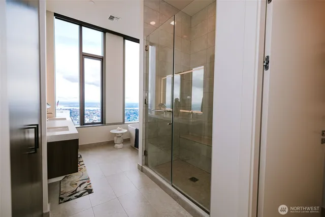 a bathroom with a glass shower door