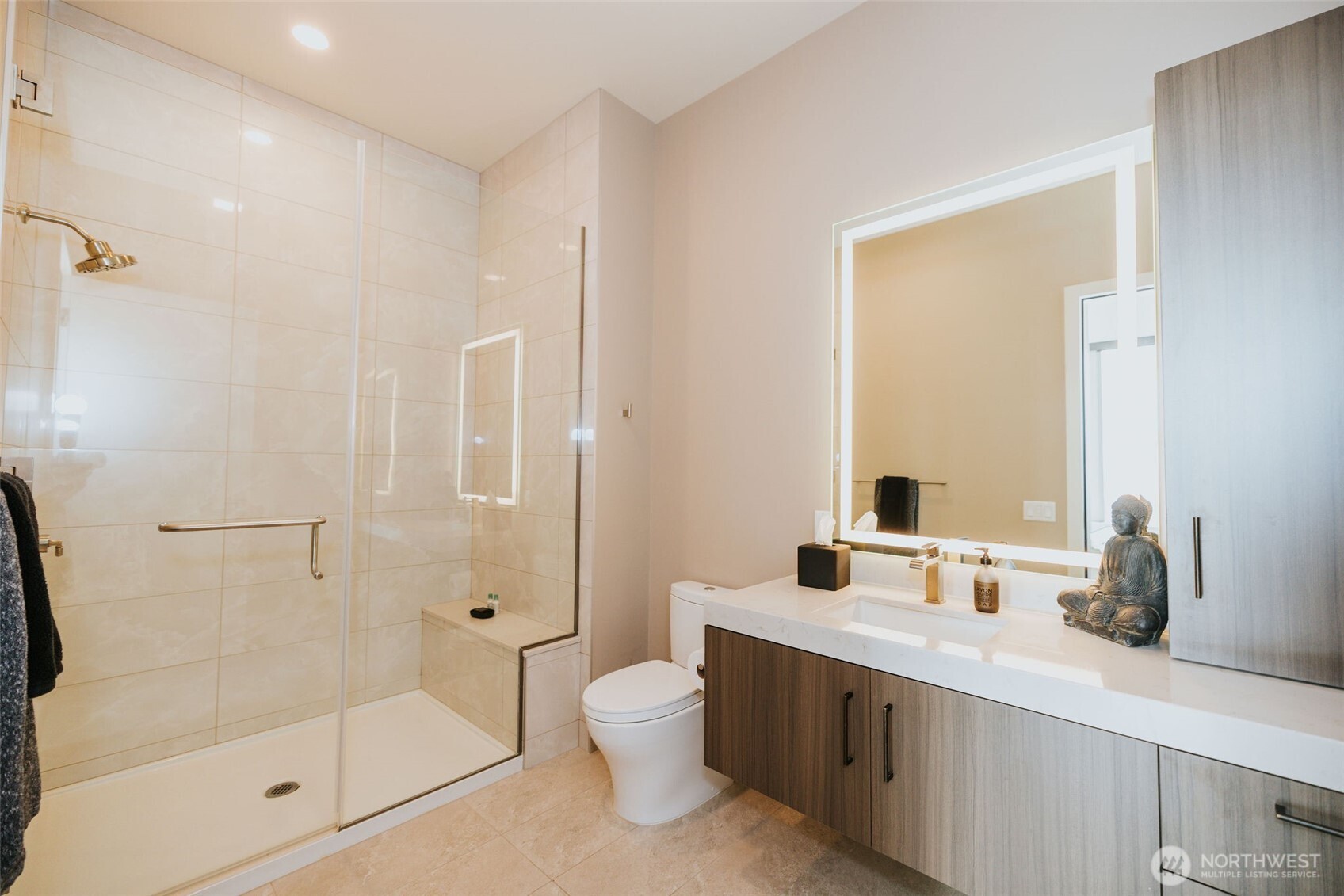 1340 4th Avenue, Unit 5803 Seattle, WA 98101 - Photo 28 of 39 a bathroom with a double vanity sink toilet mirror and shower